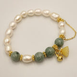 White pearl and jade bracelet with flower pendant